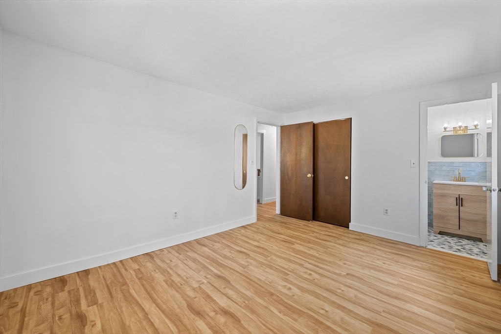 3 Lark Drive Hudson, MA 01749 - Photo 20 of 38 a view of empty room with wooden floor and fireplace