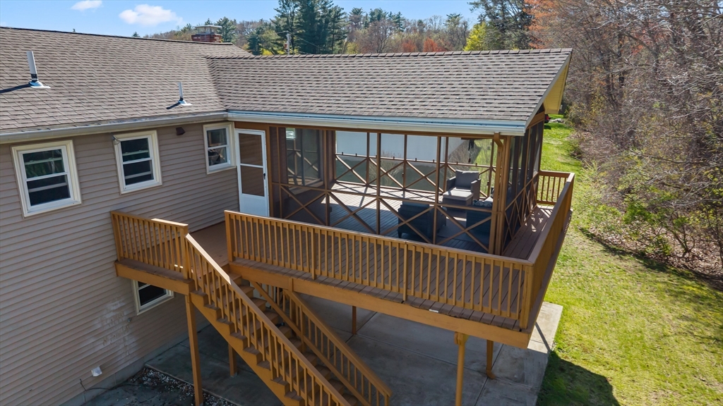 3 Lark Drive Hudson, MA 01749 - Photo 32 of 38 a view of a patio with a table chairs and wooden fence