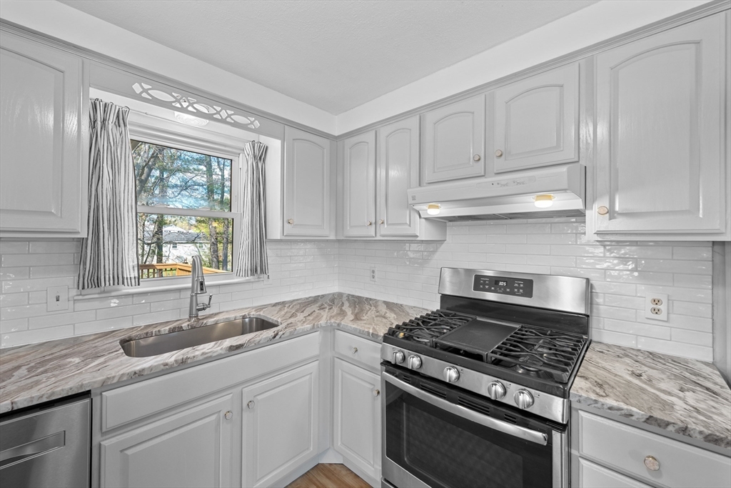 3 Lark Drive Hudson, MA 01749 - Photo 10 of 38 a kitchen with granite countertop white cabinets and appliances