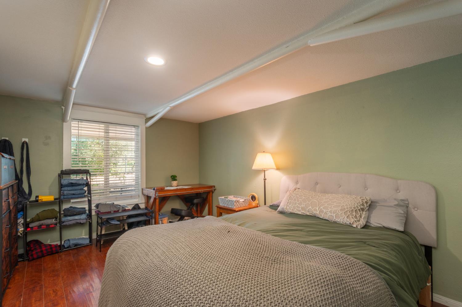 15663 Ojai Road Santa Paula, CA 93060 - Photo 28 of 47 a bedroom with a bed and wooden floor
