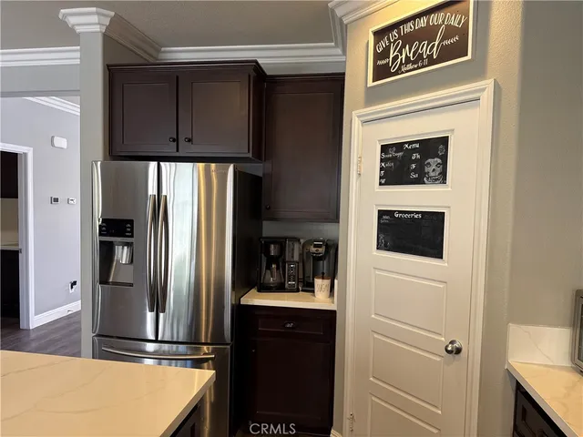 a kitchen with stainless steel appliances granite countertop a refrigerator and a stove