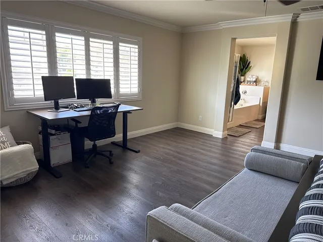 a view of a livingroom with workspace and a window