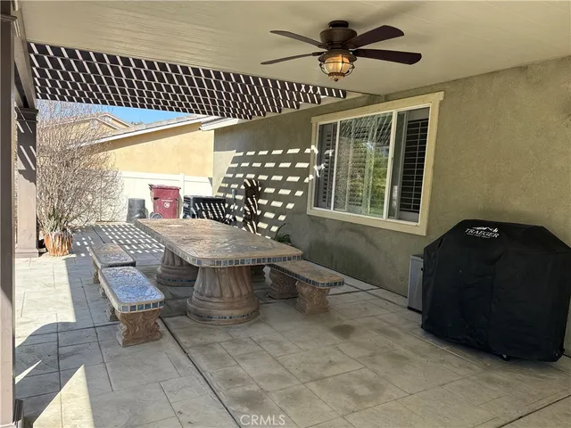 a view of a patio with table and chairs and potted plants