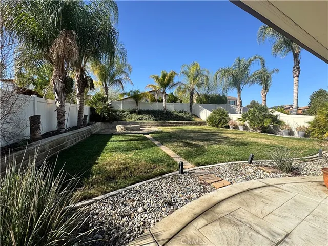 a view of a house with backyard and sitting area