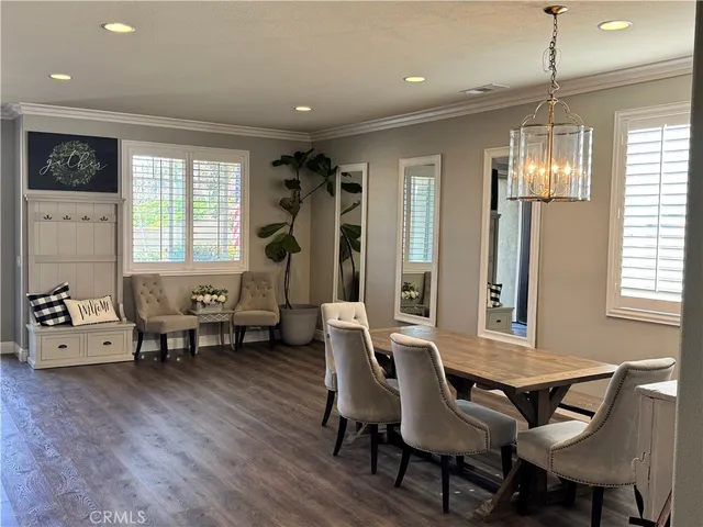 a view of a a dining room with furniture window and wooden floor