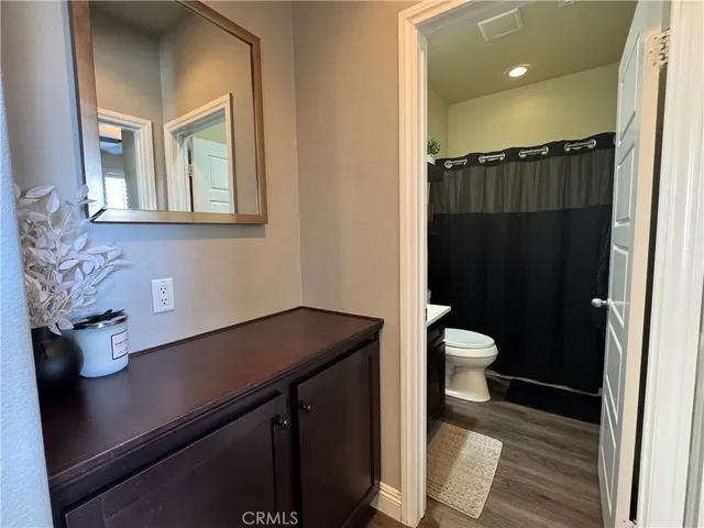 a bathroom with a sink a toilet and mirror