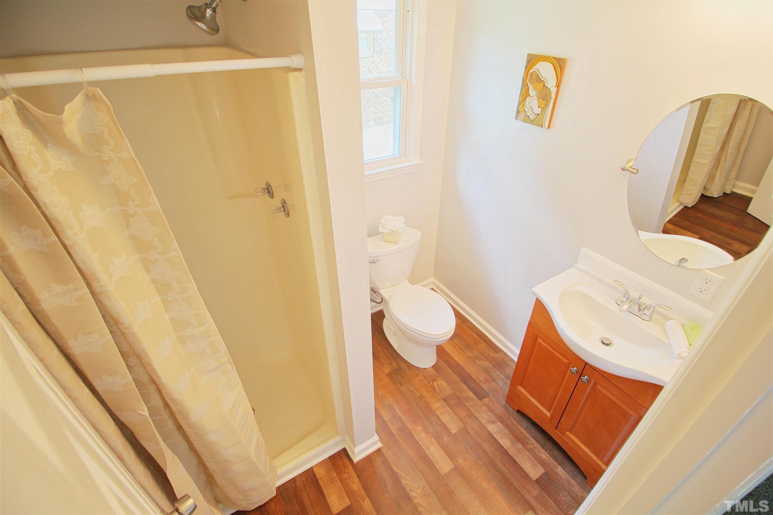 548 Dacian Road Raleigh, NC 27610 - Photo 13 of 16 a bathroom with a sink and a mirror