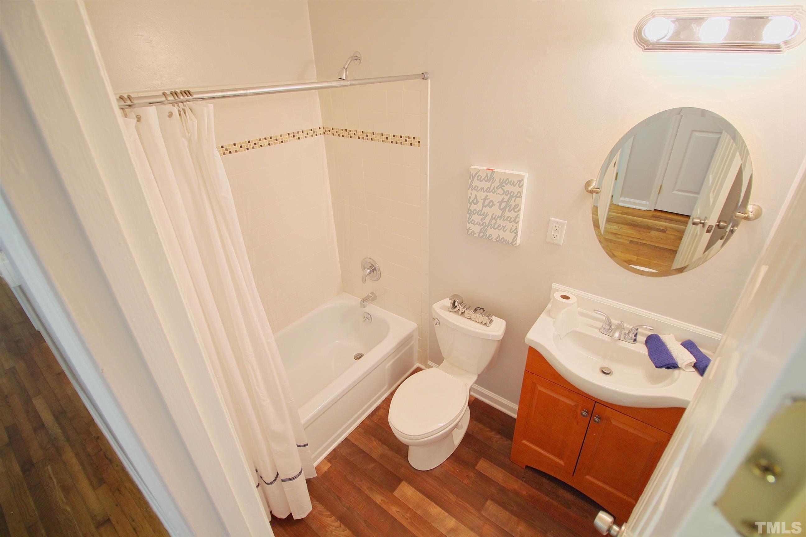 548 Dacian Road Raleigh, NC 27610 - Photo 5 of 16 a bathroom with a sink and a mirror