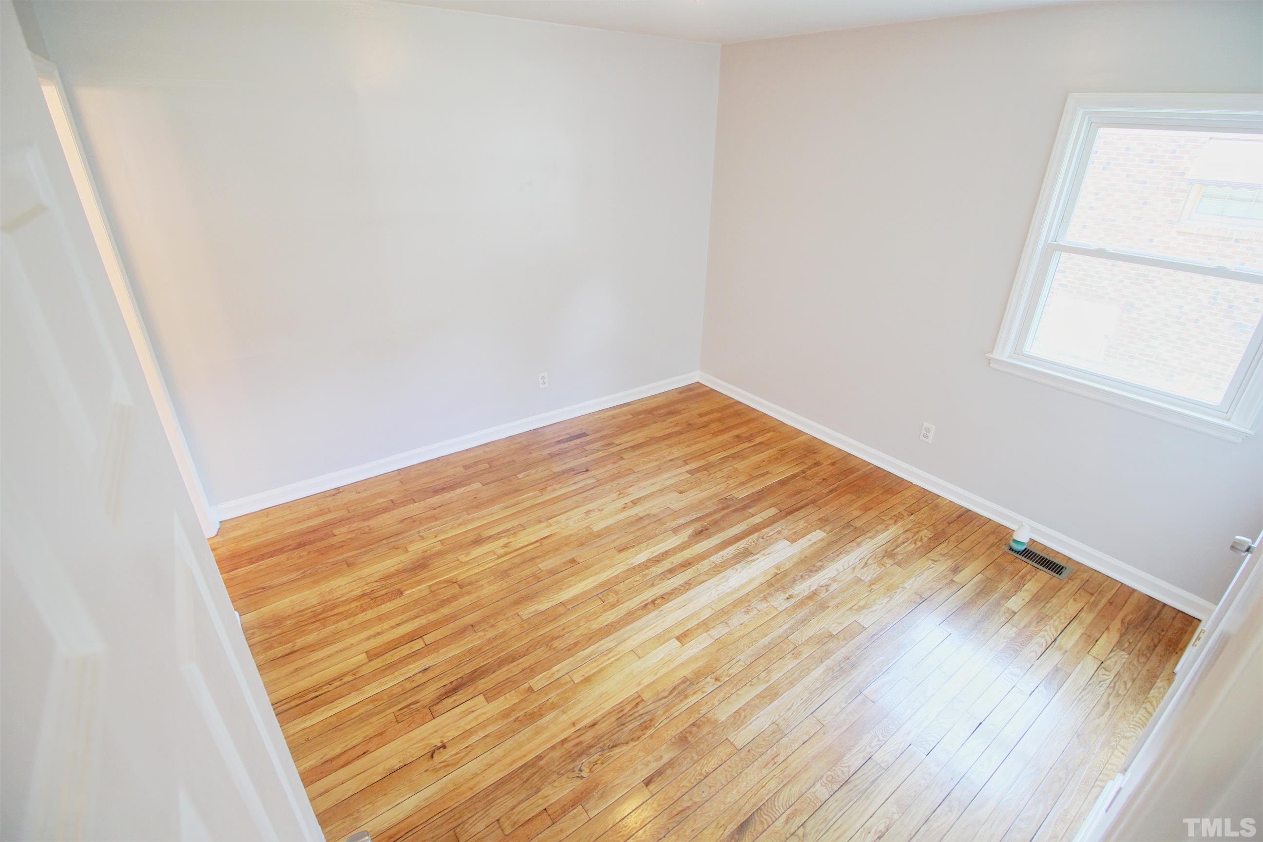 548 Dacian Road Raleigh, NC 27610 - Photo 6 of 16 a view of empty room with wooden floor and fan