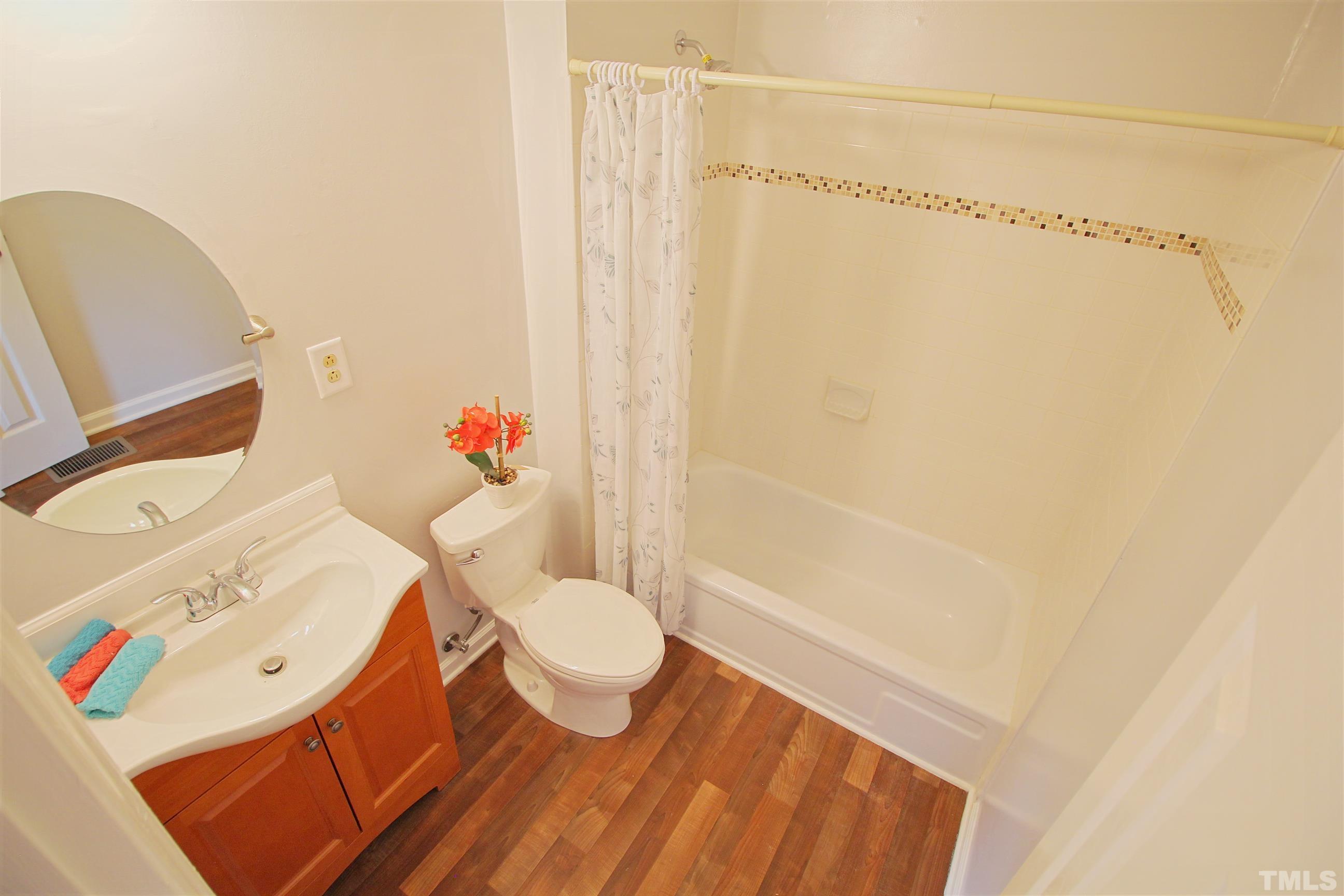 548 Dacian Road Raleigh, NC 27610 - Photo 7 of 16 a bathroom with a sink toilet and shower