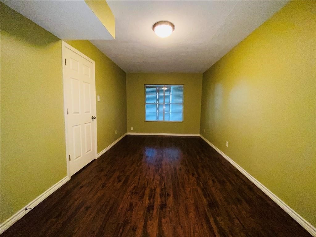 310 Sunset Boulevard Portland, TX 78374 - Photo 12 of 18 a view of an empty room with wooden floor and a window