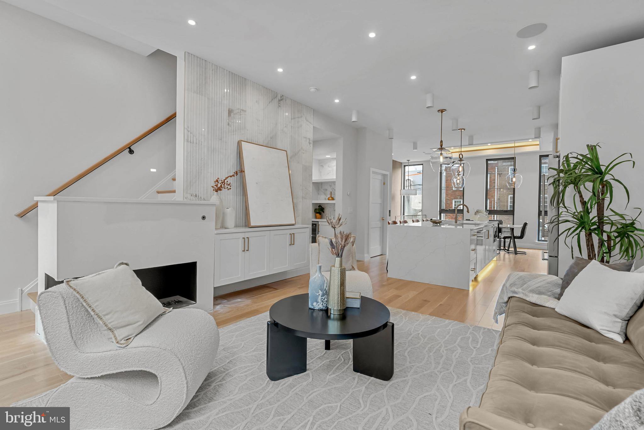 1100 Webster Street, Unit 4 Philadelphia, PA 19147 - Photo 16 of 53 a living room with furniture a fireplace and a chandelier