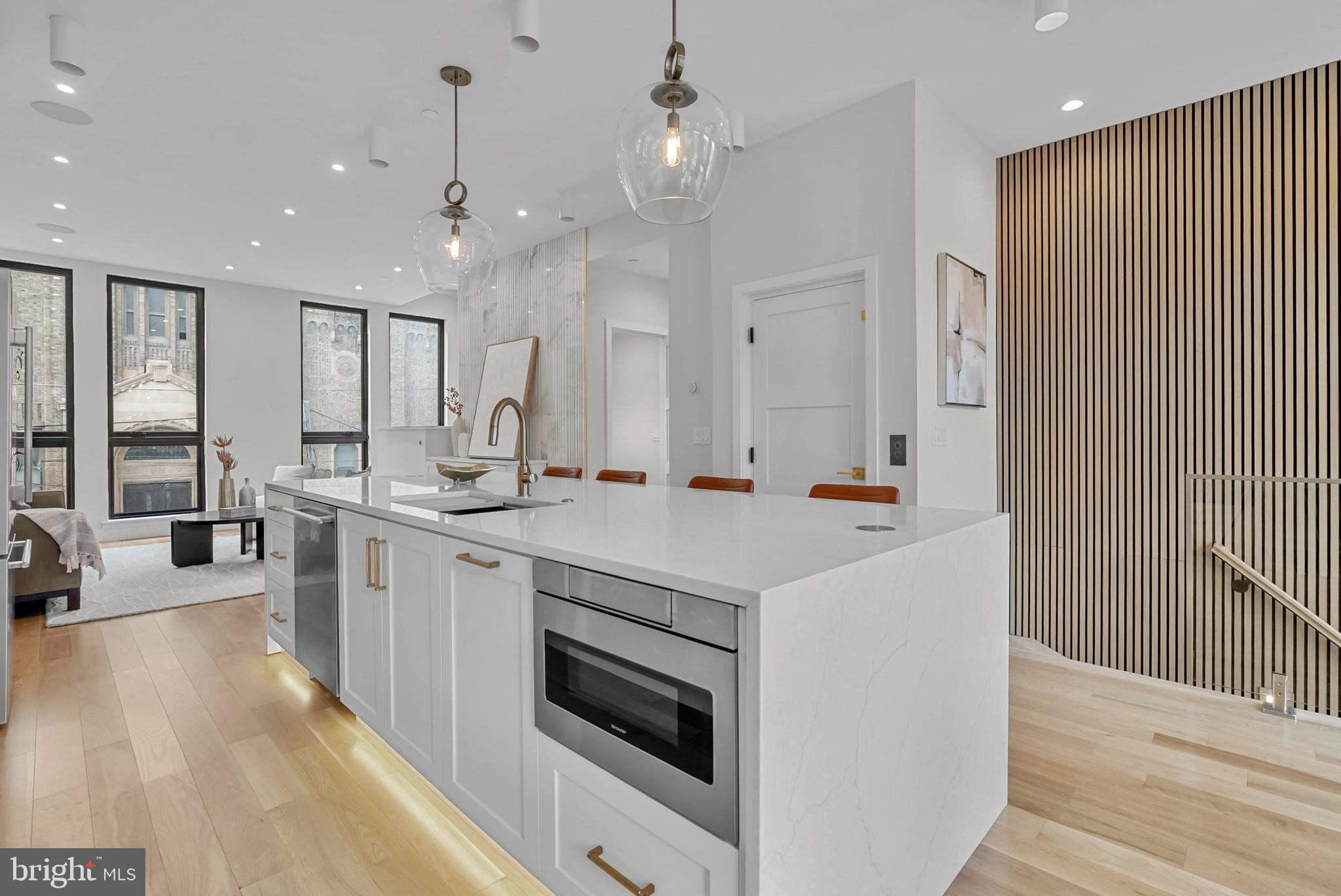 1100 Webster Street, Unit 4 Philadelphia, PA 19147 - Photo 4 of 53 a large kitchen with kitchen island a sink stainless steel appliances and cabinets