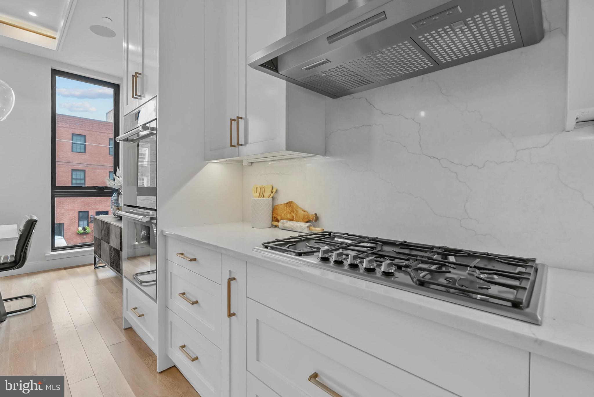 1100 Webster Street, Unit 4 Philadelphia, PA 19147 - Photo 7 of 53 a kitchen with granite countertop a stove and cabinets