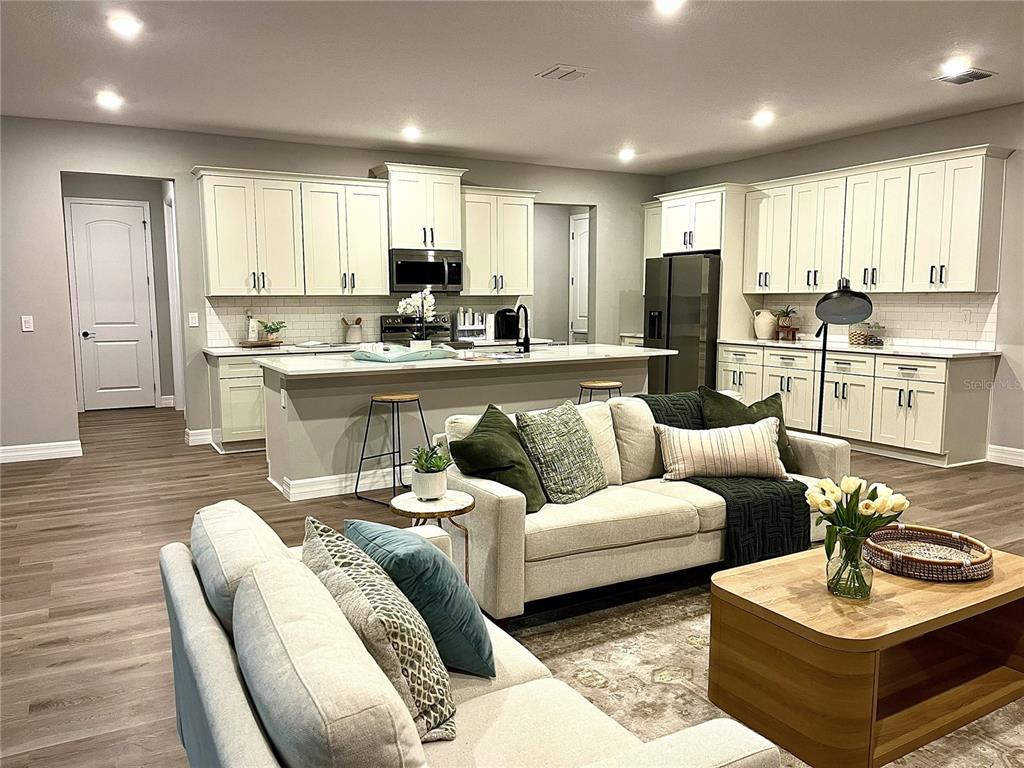 15195 Dusky Warbler Road Brooksville, FL 34614 - Photo 5 of 8 a living room kitchen with furniture and a kitchen