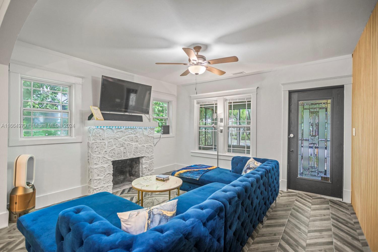 46 Northeast 43rd Street Miami, FL 33137 - Photo 1 of 42 a living room with furniture and a fireplace