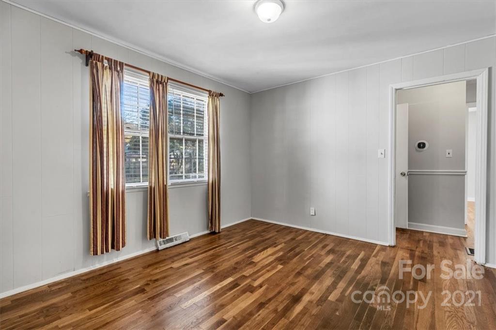 4919 Seacroft Road Charlotte, NC 28210 - Photo 15 of 25 a view of empty room with wooden floor and fan