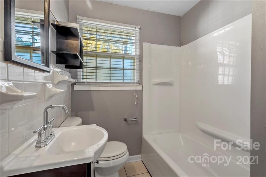 4919 Seacroft Road Charlotte, NC 28210 - Photo 17 of 25 a bathroom with a sink toilet and tub
