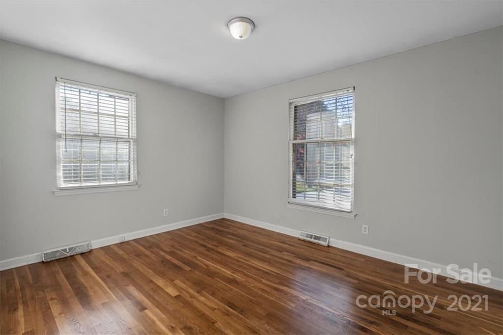 4919 Seacroft Road Charlotte, NC 28210 - Photo 19 of 25 a view of an empty room with wooden floor and a window