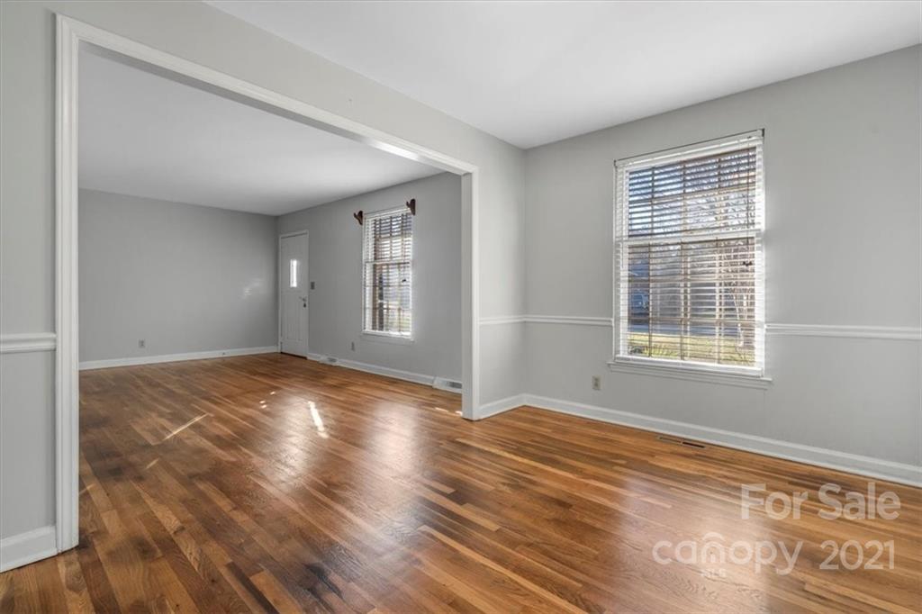 4919 Seacroft Road Charlotte, NC 28210 - Photo 6 of 25 a view of empty room with wooden floor and fan
