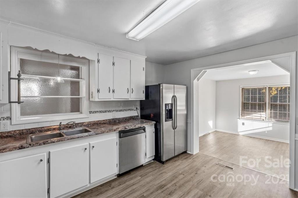 4919 Seacroft Road Charlotte, NC 28210 - Photo 8 of 25 a kitchen with a refrigerator and a sink