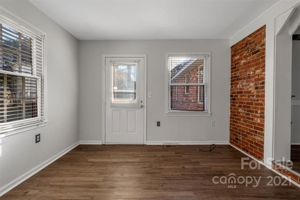 4919 Seacroft Road Charlotte, NC 28210 - Photo 10 of 25 a view of an empty room with wooden floor and a window