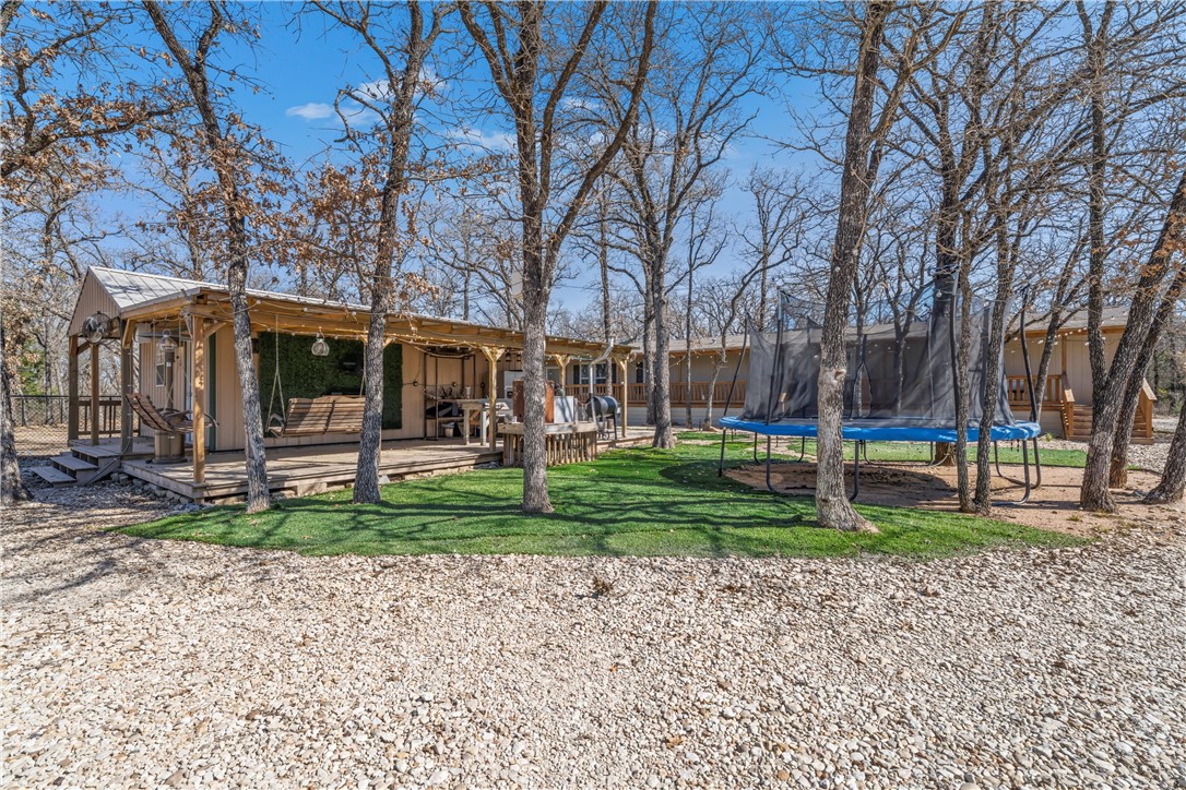 5481 Tokio Road West, TX 76691 - Photo 5 of 23 a view of a house with a backyard and a tree