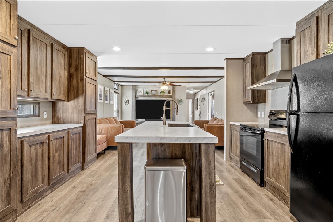 5481 Tokio Road West, TX 76691 - Photo 9 of 23 a kitchen with stainless steel appliances kitchen island a stove and a refrigerator