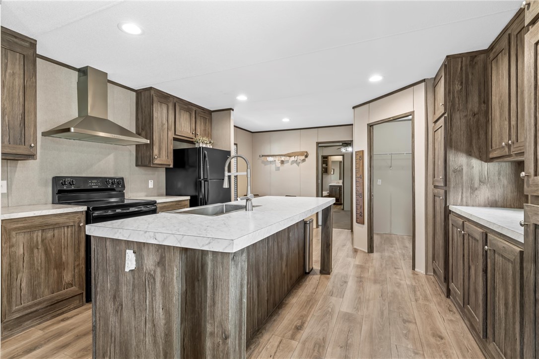 5481 Tokio Road West, TX 76691 - Photo 10 of 23 a kitchen with stainless steel appliances a sink stove refrigerator and cabinets