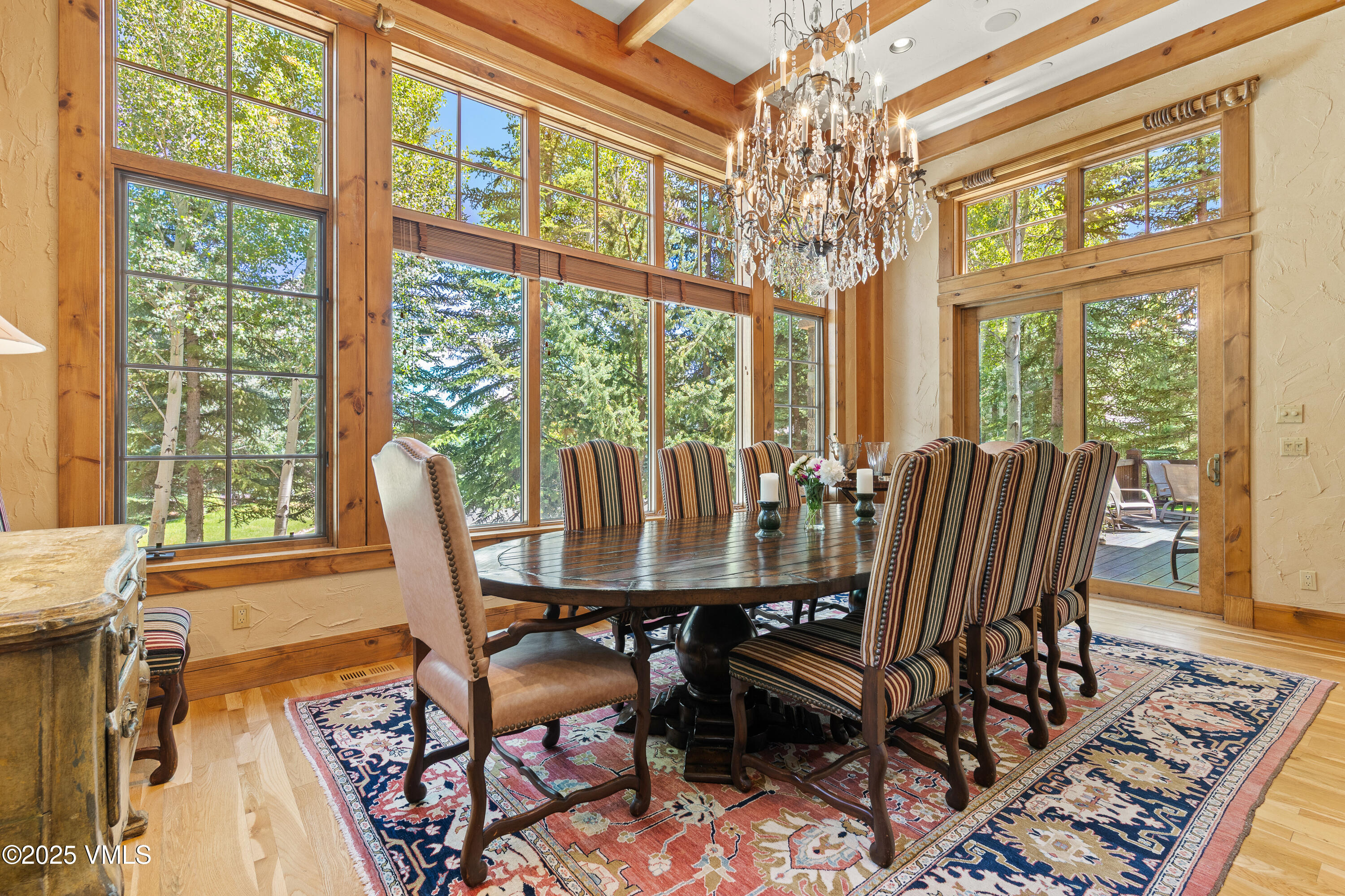 33 Grey Hawk Lane Edwards, CO 81632 - Photo 13 of 78 a view of a dining room with furniture large windows wooden floor and chandelier