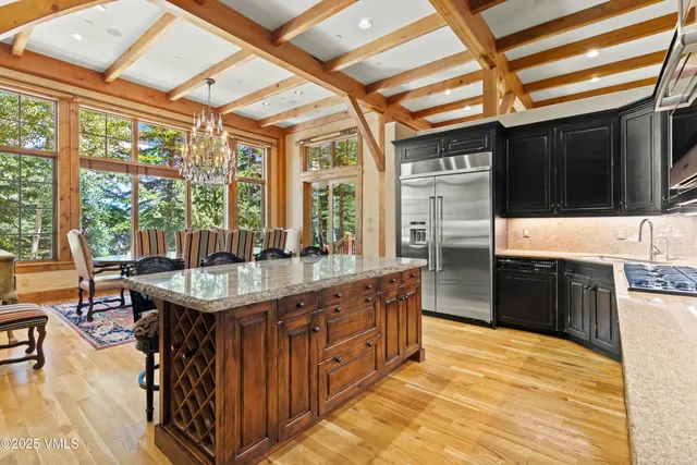 a kitchen with stainless steel appliances granite countertop a sink stove and cabinets