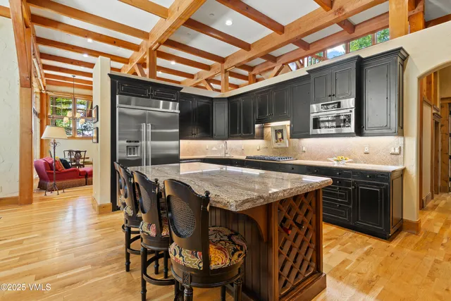 a view of a hallway with wooden floor and entryway