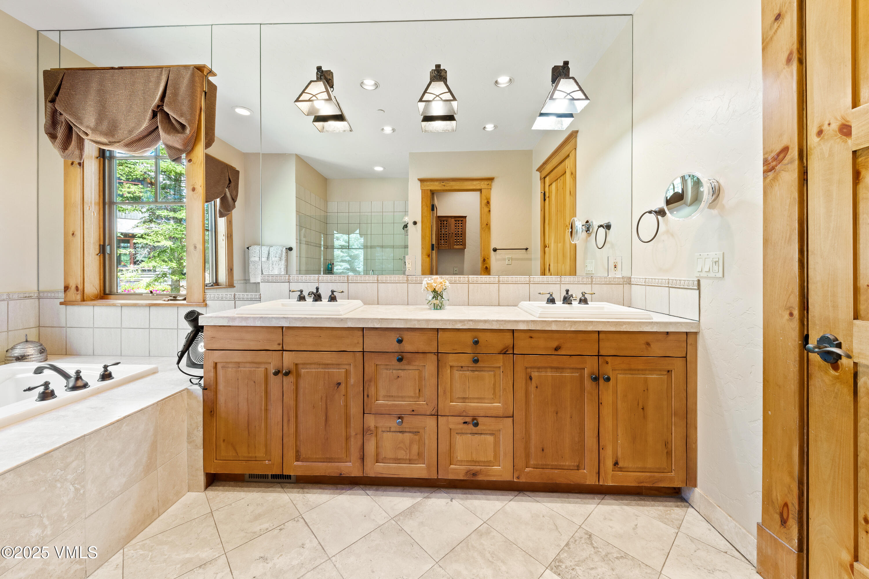 33 Grey Hawk Lane Edwards, CO 81632 - Photo 25 of 78 a spacious bathroom with a double vanity sink large mirror and a bathtub