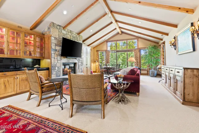 a bathroom with a granite countertop toilet sink and mirror