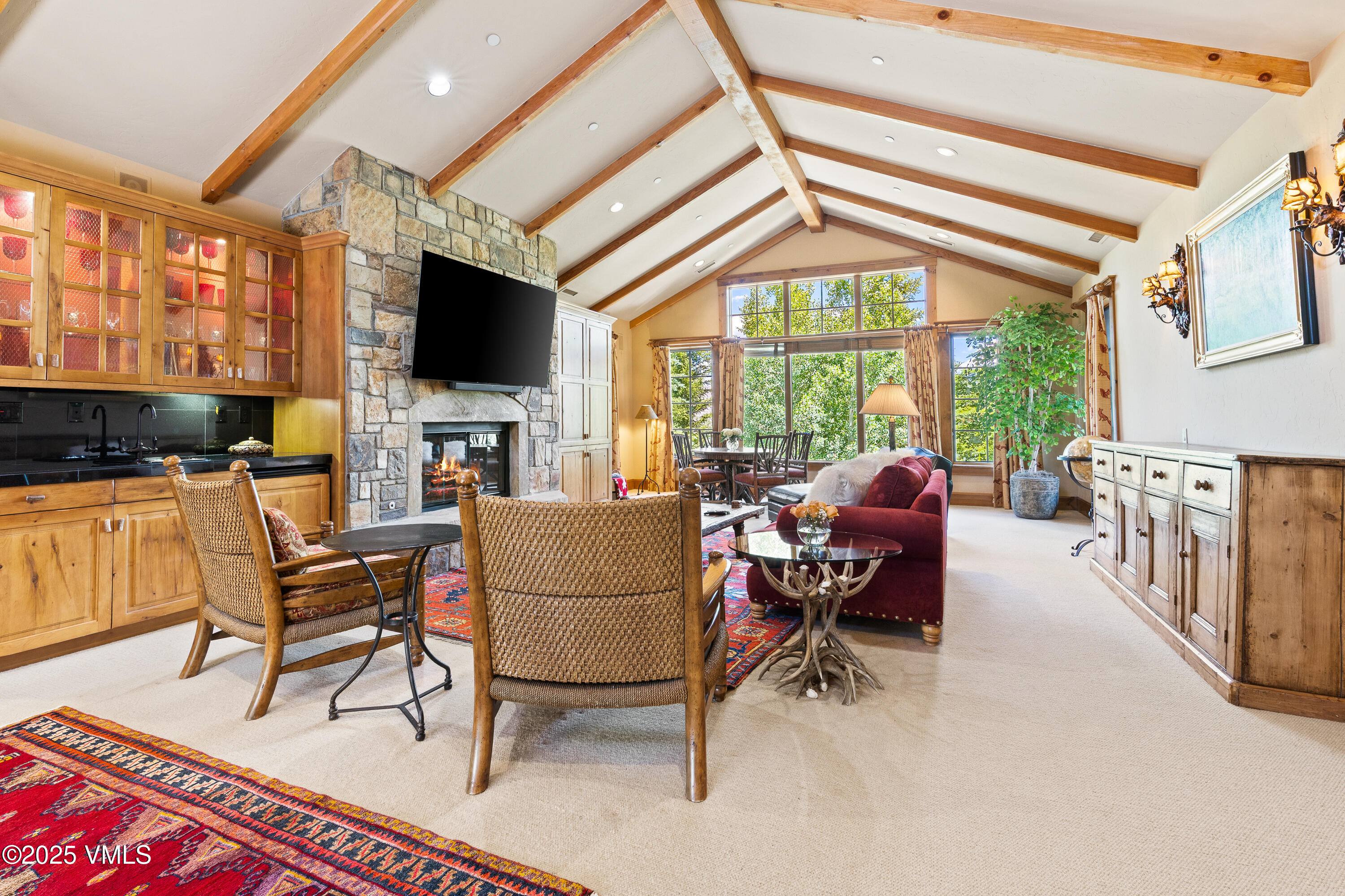 33 Grey Hawk Lane Edwards, CO 81632 - Photo 31 of 78 a living room with furniture a flat screen tv and a floor to ceiling window