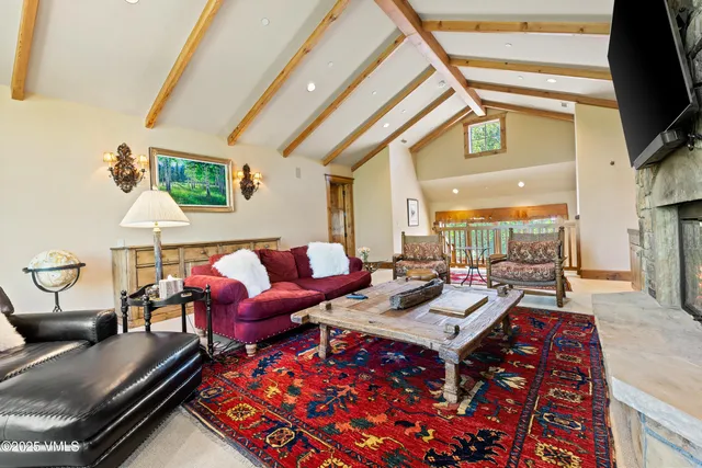 a bedroom with a bed and a large window with balcony view