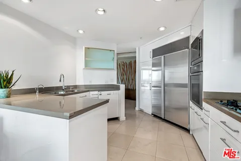 a kitchen with stainless steel appliances kitchen island granite countertop a table and chairs
