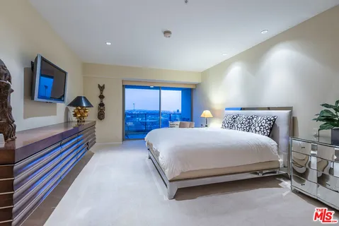 a bed room with a bed and a large window