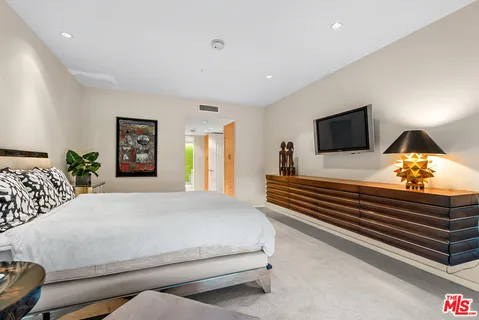 a bedroom with a bed and lamp