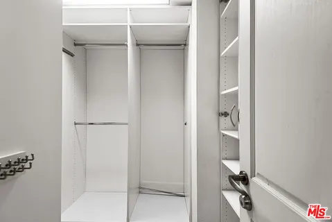 a spacious bathroom with a double vanity sink large mirror and bathtub