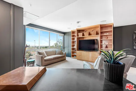 a living room with furniture gym equipment and a rug
