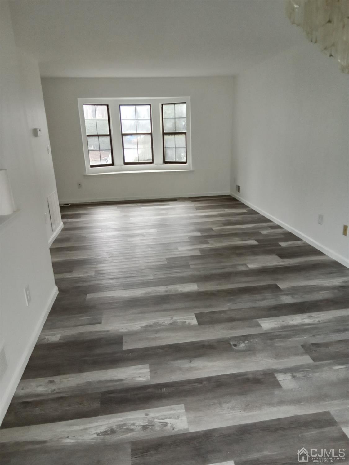 1403 Timber Oaks Road Edison, NJ 08820 - Photo 2 of 6 a view of wooden floor and windows in a room