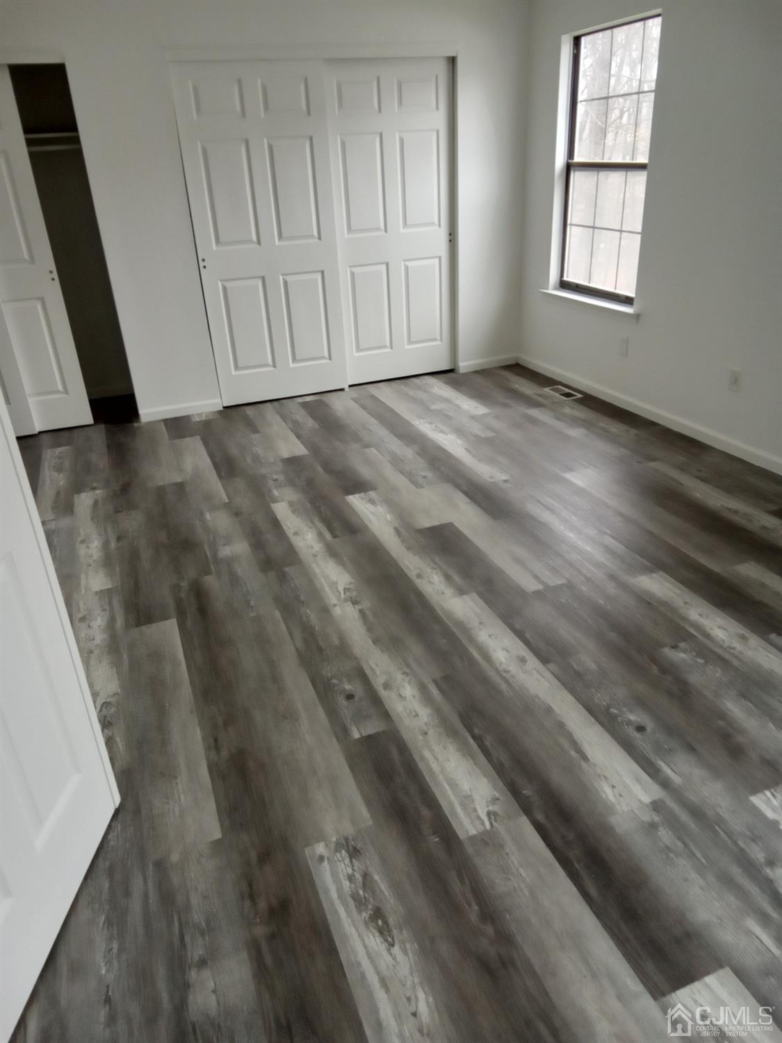 1403 Timber Oaks Road Edison, NJ 08820 - Photo 6 of 6 a view of a livingroom with wooden floor and window