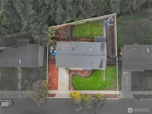 an aerial view of a house with a yard