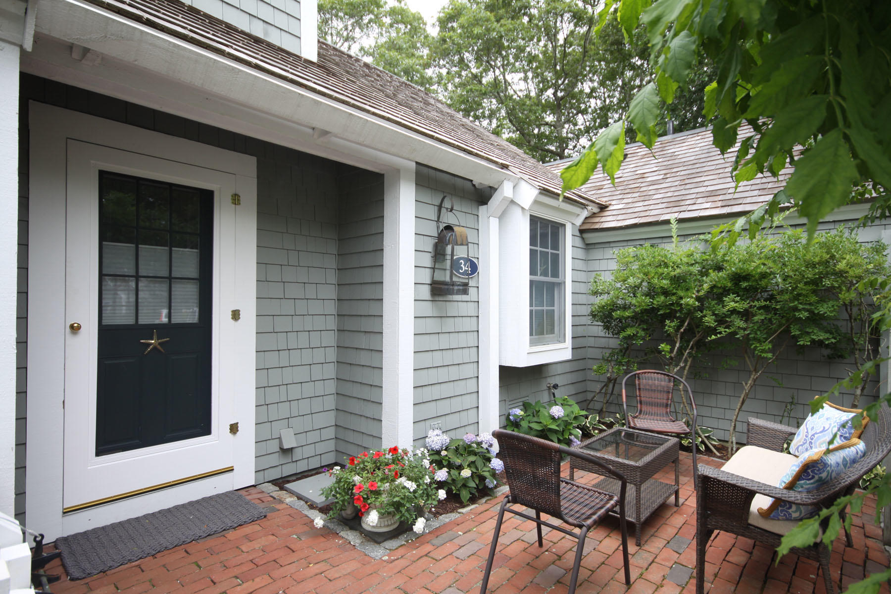 a view of a chairs and table in a back yard of the house