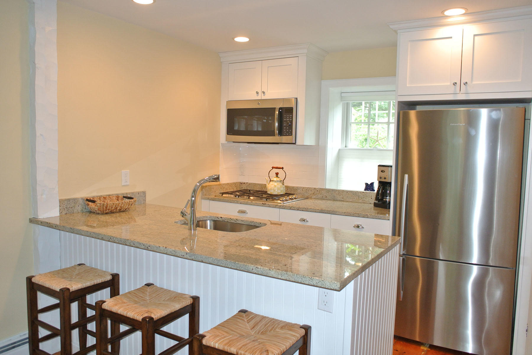 34 Brant Rock Road Mashpee, MA 02649 - Photo 2 of 15 a kitchen with a refrigerator and a sink