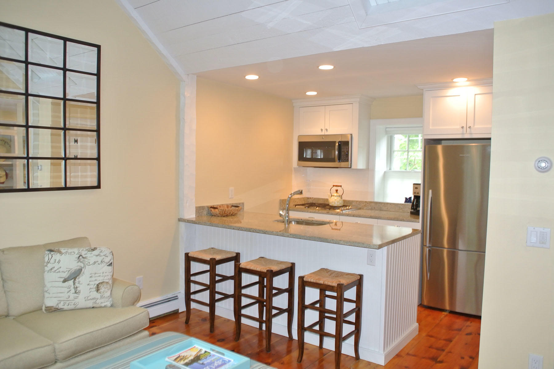 34 Brant Rock Road Mashpee, MA 02649 - Photo 5 of 15 a kitchen with stainless steel appliances a sink a stove a refrigerator and cabinets