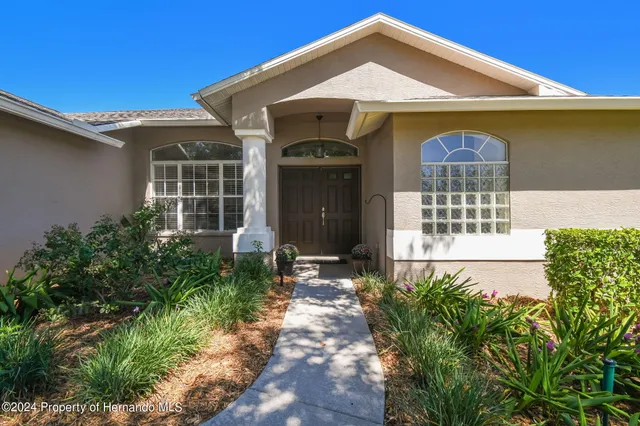 an empty room with wooden floor windows