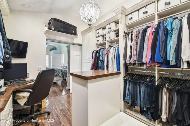 a view of a lake with a yard and large trees