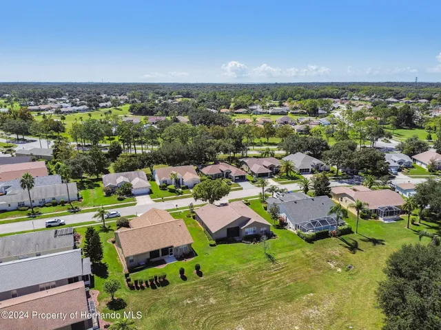 a room with lots of trees and a wooden fence